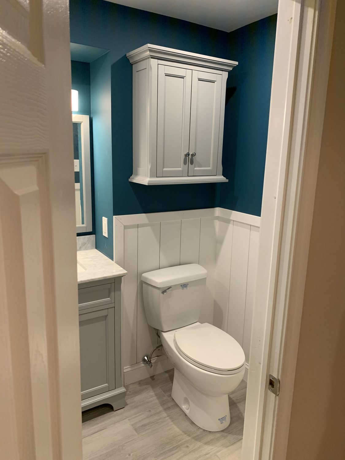 Finished bathroom with vanity, toilet, and updated finishes