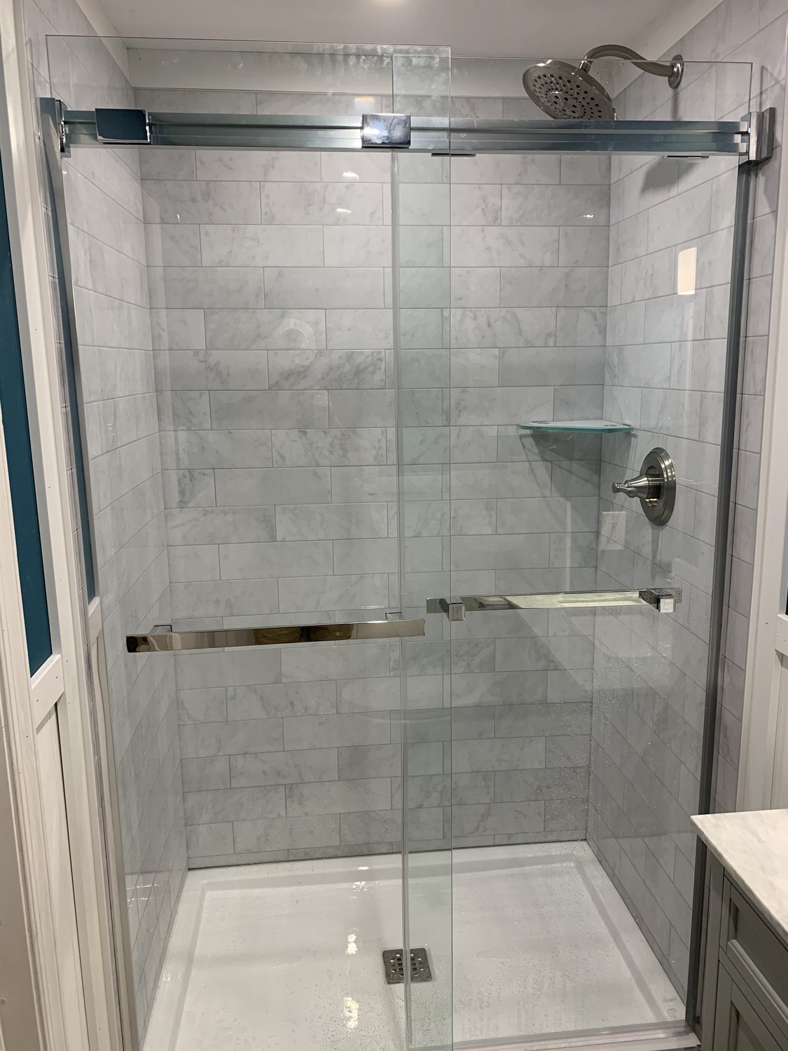 Completed tiled shower with glass enclosure