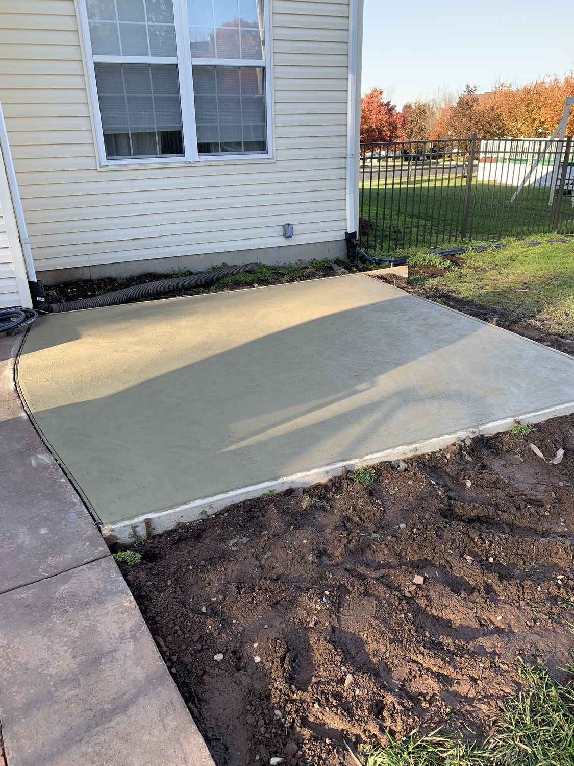 Newly poured concrete patio beside a home