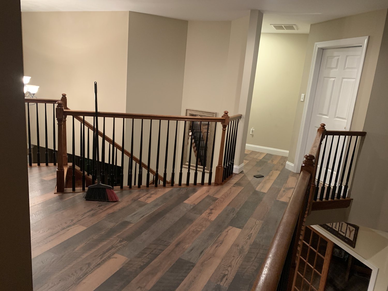 Completed wood-look flooring and stair railing